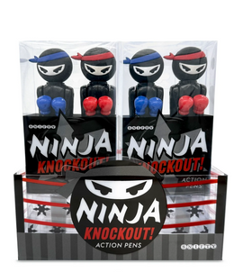A display box of Ninja Knockout Action Pens by Snifty. The package contains two ninja figurines, one wearing a blue headband and the other sporting a red headband, with exaggerated boxing gloves. The pens are designed in a playful, cartoonish style, appealing to both kids and adults who enjoy whimsical stationery.