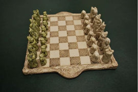 Teddy Celts Chess Set from O'Gowna Studios featuring intricately designed chess pieces in green and cream tones arranged on an ornate chessboard with Celtic patterns.