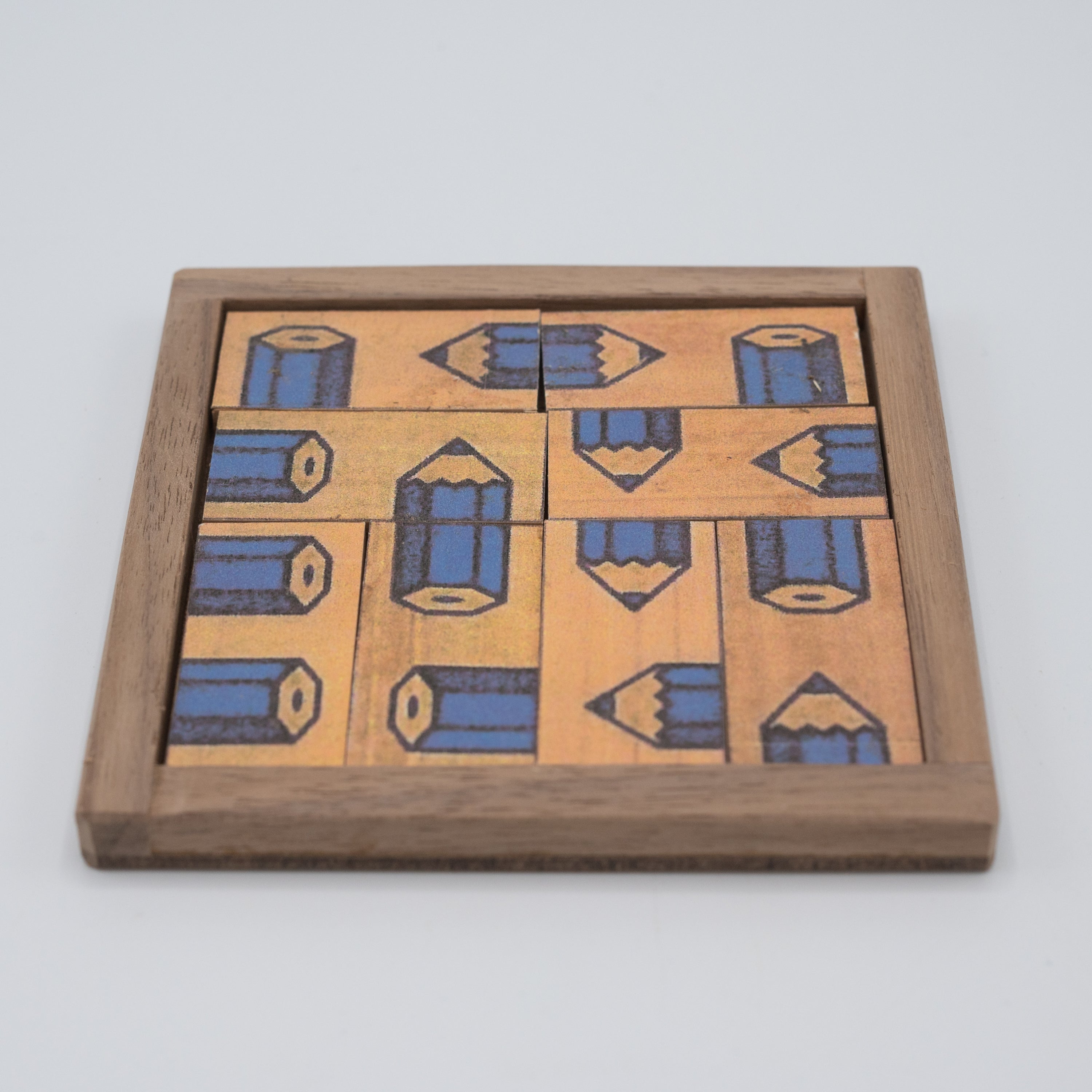 The Blue Pencil Puzzle by Saul Bobroff is a mechanical puzzle featuring intricately designed wooden pieces arranged to resemble pencils. The puzzle is encased in a light wood frame with a smooth finish, offering a visually appealing challenge for puzzle enthusiasts. Each piece has a vibrant blue and yellow color scheme, making it both a decorative and stimulating item.