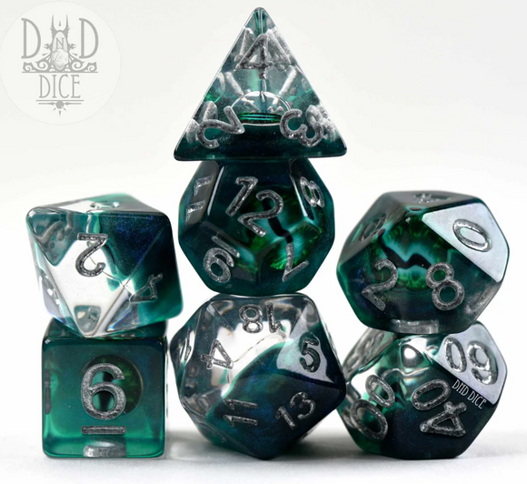 Watchful Eye Reptile 7-piece RPG dice set by DND Dice. The set includes various polyhedral dice made of translucent material with green and black swirls, featuring silver numbers. The dice are arranged attractively, showcasing their unique designs and colors, ideal for tabletop gaming enthusiasts.