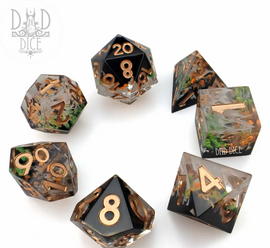 Set of 7 RPG dice featuring a Toadstool Thicket design. The dice have a transparent resin finish with earthy colors and embedded details resembling moss and leaves. Numeric gold accents highlight the numbers for easy readability, perfect for tabletop gaming enthusiasts.