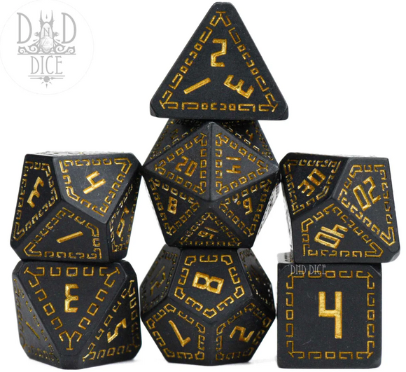 A set of seven black RPG dice from DND Dice, featuring gold numbers and symbols. This Olympian: Hades collection includes various shapes such as a d20, d12, d10, and d8, ideal for tabletop gaming enthusiasts.