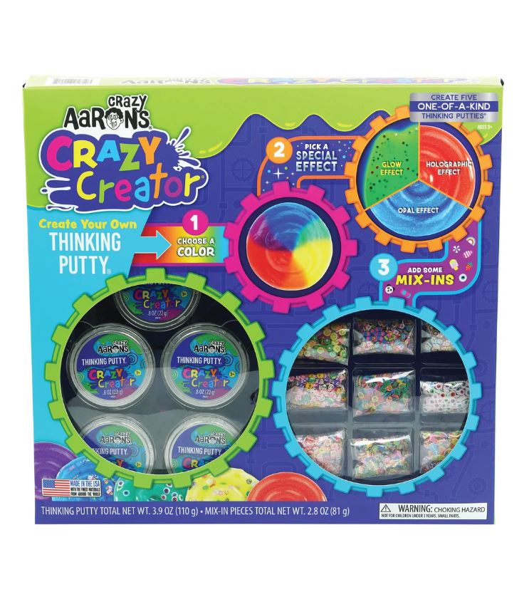 The Crazy Creator Kit by Crazy Aaron includes various colors of thinking putty and mix-ins. The kit's vibrant packaging showcases the steps for creating custom putty, which can have special effects. It features six containers of putty and multiple mix-ins such as glitter and confetti, providing a fun DIY experience for all ages.