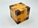 A beautifully crafted wooden mechanical puzzle titled 'Convolution - STC #30' by Stewart Coffin. The puzzle features intricate interwoven patterns consisting of various shades of wood, including light and dark tones, creating a visually appealing design. This three-dimensional puzzle challenges the mind while serving as an elegant decorative piece.