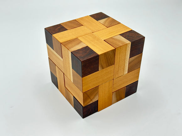 A beautifully crafted wooden mechanical puzzle titled 'Convolution - STC #30' by Stewart Coffin. The puzzle features intricate interwoven patterns consisting of various shades of wood, including light and dark tones, creating a visually appealing design. This three-dimensional puzzle challenges the mind while serving as an elegant decorative piece.
