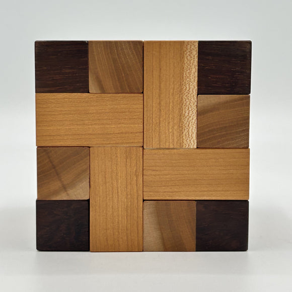 Convolution - STC #30 mechanical puzzle by Stewart Coffin. Features an intricate design made of various wood pieces, showcasing a unique interlocking structure that challenges problem-solving skills.