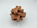 Twelve Piece Separation-STC 85 by Stewart Coffin, crafted from intricately joined wooden pieces, forming a unique and engaging mechanical puzzle. The puzzle features various geometric shapes and a compact, artistic design, ideal for enhancing spatial reasoning and providing an enjoyable challenge for enthusiasts.
