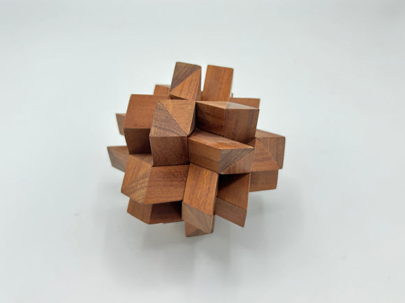 Twelve Piece Separation-STC 85 by Stewart Coffin, crafted from intricately joined wooden pieces, forming a unique and engaging mechanical puzzle. The puzzle features various geometric shapes and a compact, artistic design, ideal for enhancing spatial reasoning and providing an enjoyable challenge for enthusiasts.