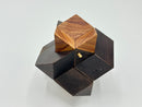 Rosebud -STC #39 with peg is a beautifully crafted mechanical puzzle by Stewart Coffin. It features an intricate design with contrasting dark and light wood pieces that fit together to form a multi-dimensional shape, providing a challenging yet rewarding experience for puzzle enthusiasts.