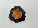 Rosebud -STC #39 w/peg by Stewart Coffin, a beautifully crafted mechanical puzzle made from fine wood. The puzzle features an intricate design with contrasting dark and light wood pieces, showcasing a unique shape that invites challenge and engagement.