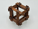 The RD Skeleton by Dubois is a beautifully crafted mechanical puzzle composed of intricately connected wooden pieces featuring a cubic design with angular accents. The puzzle is made from high-quality dark wood, lending it an elegant and sophisticated appearance. Each component showcases meticulous craftsmanship, providing both a challenge and a visually appealing decorative piece for puzzle enthusiasts.