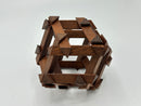 Top view of the RD Skeleton by Dubois, a handcrafted wooden mechanical puzzle featuring intricate interlocking pieces, designed by Philippe Dubois. The puzzle showcases a rich brown finish with pointed accents, enhancing its artistic appeal.