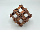 The RD Skeleton by Dubois is a beautifully crafted mechanical puzzle made of dark wood. Its intricate design features a three-dimensional woven pattern with pointed ends, creatively challenging the solver to disassemble and reassemble its pieces. This luxurious puzzle is perfect for enthusiasts seeking both beauty and brain-teasing fun.