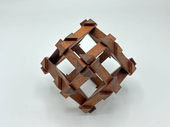 The RD Skeleton by Dubois is a beautifully crafted mechanical puzzle made of dark wood. Its intricate design features a three-dimensional woven pattern with pointed ends, creatively challenging the solver to disassemble and reassemble its pieces. This luxurious puzzle is perfect for enthusiasts seeking both beauty and brain-teasing fun.