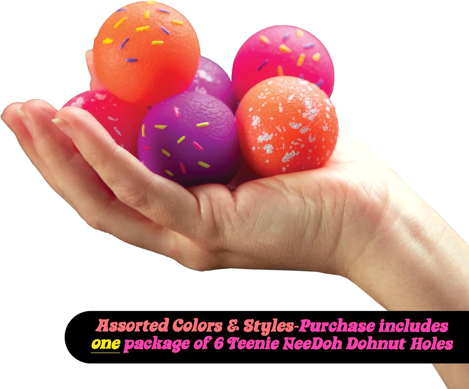 A hand holding a colorful assortment of six Teenie Nee Doh Donut Holes in vibrant colors including orange, pink, and purple, each decorated with colorful sprinkles. The items are squishy sensory toys designed for stress relief and play.