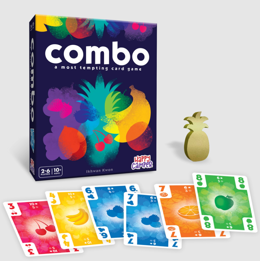 The Combo card game by Happy Camper, featuring a colorful box design with fruits, a golden pineapple token, and vibrant playing cards displaying various fruits and numbers. Suitable for 2-6 players aged 10 and up.