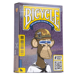 Bicycle Bored Ape playing cards from US Playing Card Co. featuring a cartoon monkey wearing a sailor outfit and glasses on the packaging. The box displays vibrant colors and graphics with the Bicycle logo at the top.