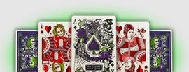 A set of Beetlejuice Playing Cards by Theory 11 featuring unique illustrations of characters and scenes from the classic film. The cards display vibrant colors, including green, red, and purple, showcasing artistic renditions of Beetlejuice, Lydia, and other iconic elements like a spiderweb and the haunted house, perfect for collectors and fans of the movie.