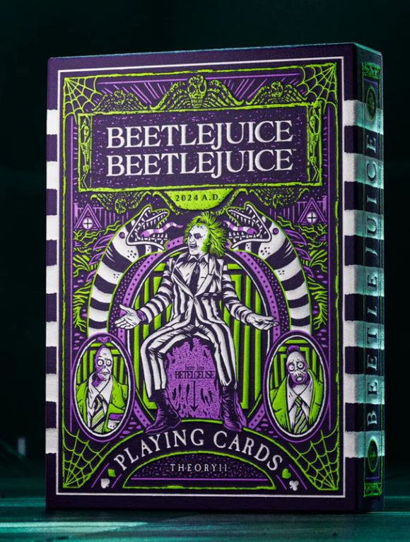 Beetlejuice Playing Cards designed by Theory 11, showcasing vibrant green and purple artwork featuring the iconic character. The packaging has intricate designs with skeletons and stripes, highlighting a blend of whimsical and spooky themes. Perfect for collectors and fans of the Beetlejuice franchise.