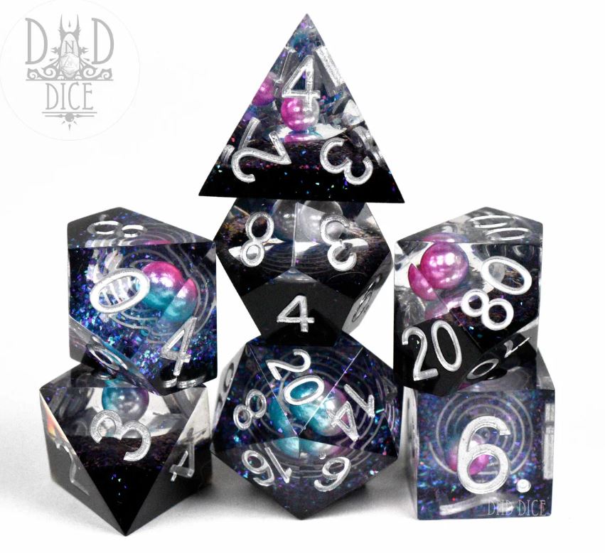 Stellar Orbit 7pc Acrylic RPG dice set by DND Dice featuring seven colorful, glittering polyhedral dice including a D20, D12, D10, D8, D6, and D4, all designed with a cosmic theme and vibrant colors.