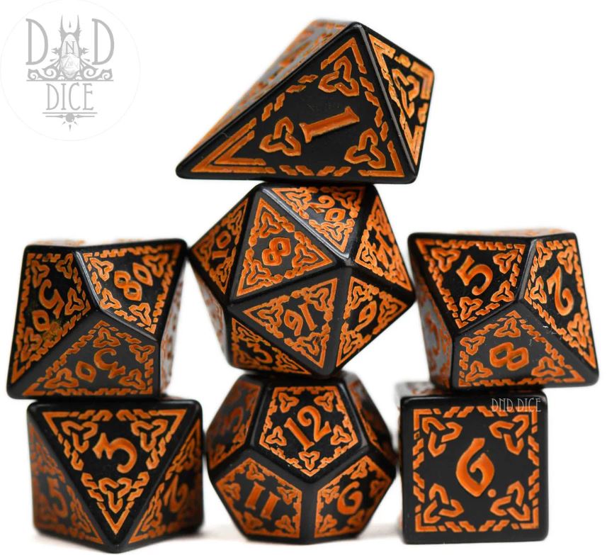 A colorful set of seven orange and black RPG dice, featuring intricately designed numbers and knotwork patterns. The set includes various types of dice, perfect for tabletop gaming.