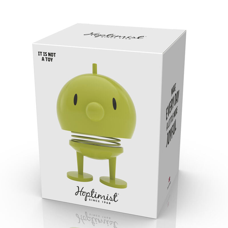 Hoptimist Bumble M Lime is a cheerful decorative toy designed to bring joy. The box packaging features the brand logo and emphasizes that it is not a toy.