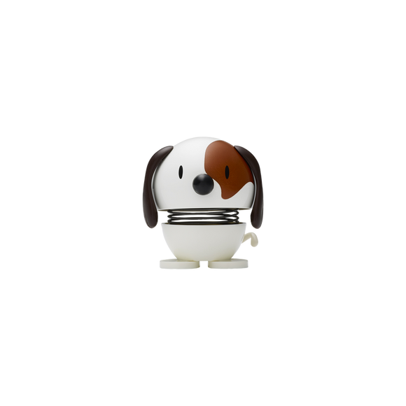 A charming Hoptimist Dog in white with a playful brown patch over one eye. The dog features a round body with movable legs and a cheerful expression, making it a delightful decorative item for the home or office.
