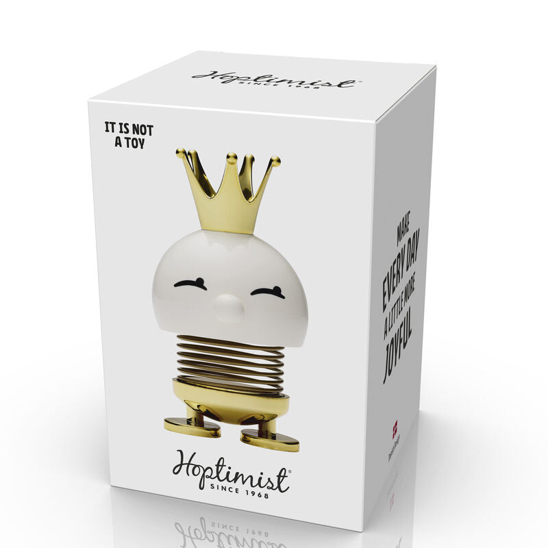 Hoptimist Princess White is a cheerful decorative item featuring a smiling character with a gold crown, crafted from high-quality materials. It is designed to add joy and whimsy to any space.