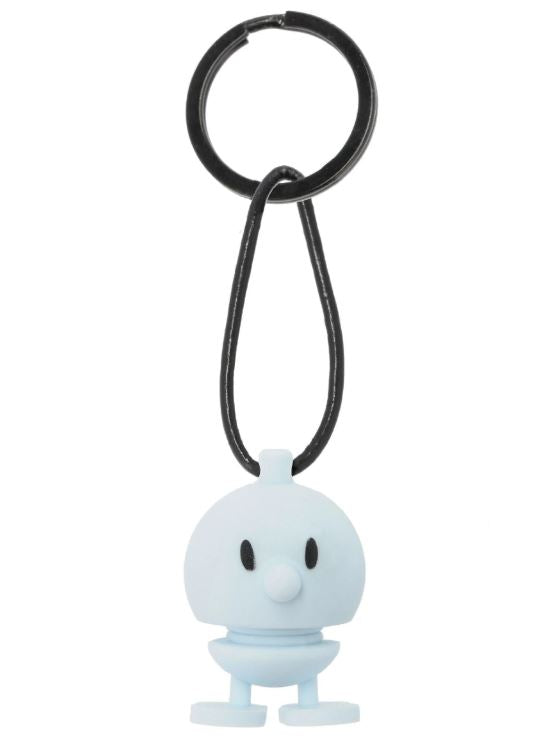 Hoptimist Keychain Bumble in blue featuring a cute design. The keychain has a rounded body with a small nose and black eyes, attached to a black loop for easy carrying.