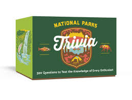 A green trivia game box titled 'National Parks Trivia' featuring a vibrant illustrated badge with images of nature and wildlife. The box highlights '390 Questions to Test the Knowledge of Every Enthusiast' for nature lovers and trivia fans.