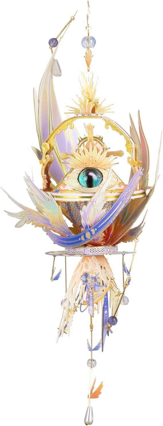 The Eye of God DIY kit by Mu Model featuring a beautifully crafted design with intricate details. The central eye is surrounded by colorful feathers and radiant embellishments, making it a stunning decorative piece.