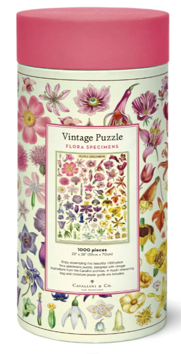 Vintage Puzzle 'Flora Specimens' 1000-piece jigsaw puzzle in a cylindrical tin container with a pink lid and a floral patterned label.