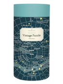 A cylindrical puzzle box for 'Vintage Puzzle' by Cavallini & Co. The box features a dark teal map design with white celestial lines and text, and a light teal top band.