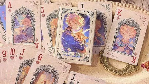 The Little Prince playing cards arranged around the card box