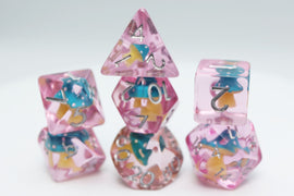 A vibrant Blue Mushroom RPG Dice Set by Foam Brain featuring a variety of multi-sided dice in a translucent pink material. The dice display intricate designs with blue and yellow mushroom motifs, gleaming metallic numbers, and varying shapes including d4, d6, d8, d10, d12, and d20, stacked playfully to showcase their unique aesthetics, perfect for tabletop gamers.