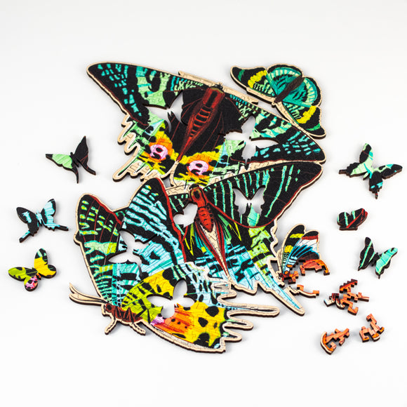 Partially assembled puzzle depicting moths, showing whimsy pieces shaped like insects