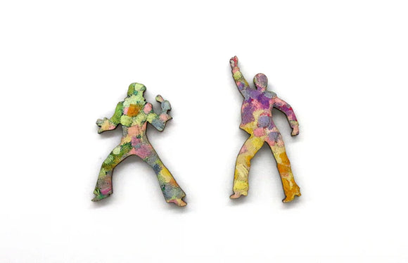 Two example pieces from the puzzle, shaped like people dancing.