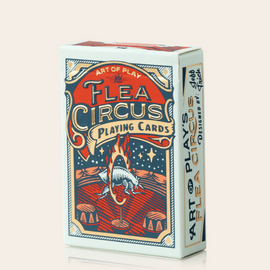 A stylish pack of Flea Circus Playing Cards from Art of Play, featuring a vibrant, colorful design with a circus theme. The box showcases intricate illustrations of a flea performing in a circus ring, surrounded by fire and props like barrels. Perfect for card games and collectors.