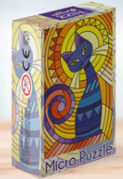 A colorful jigsaw puzzle box featuring a stylized geometric cat design. The cat, depicted in vibrant colors of blue, purple, and yellow, is surrounded by a swirling pattern. The front of the box reads 'Micro Puzzle,' suggesting a challenging and intricate puzzle experience. The background features a radiant sunburst design, enhancing the artistic appeal. Ideal for cat lovers and puzzle enthusiasts alike.