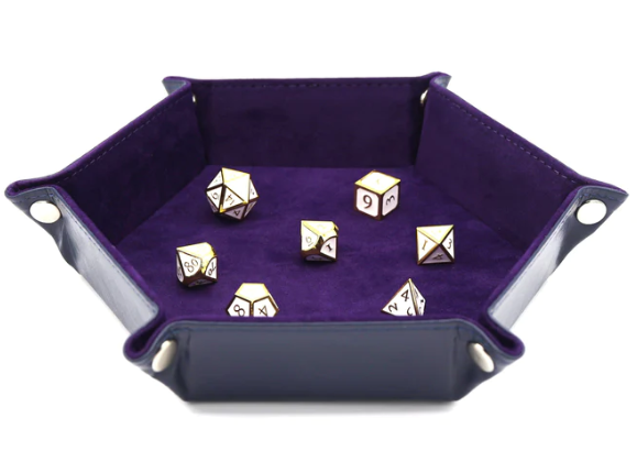 A navy leatherette and purple velvet dice tray featuring a hexagonal shape. It holds several multi-sided dice, showcasing a luxurious and stylish design ideal for gaming enthusiasts.