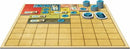 A colorful board game setup featuring a grid-based game board with various colored patches including red, yellow, and green. Tokens and scoring chips are scattered across the board, showcasing the game's strategic layout designed for competitive play.