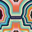 Wavelength by Palm Court is a colorful, engaging board game featuring vibrant graphics that depict silhouettes of heads intertwined with waves of color. The design emphasizes connection and communication, making it visually appealing and inviting for players.