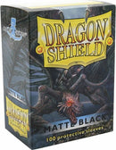 Dragon Shields pack featuring 100 black protective card sleeves. The packaging showcases a striking design with a dragon illustration and the product name 'Dragon Shield' prominently displayed. Ideal for protecting trading cards and other gaming materials.