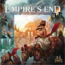 Empire's End game box by Brotherwise Games, featuring stunning artwork by Kwanchai Moriya. The cover showcases a majestic scene with a woman in a flowing dress riding an elephant, surrounded by ancient ruins and various characters, depicting the grandeur and historical themes of the game.
