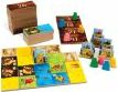 Kingdomino board game by Blue Orange U.S.A. featuring a colorful setup with domino-style tiles depicting landscapes, a scoring grid, and player pieces. The box is displayed nearby, emphasizing the game's family-friendly design and strategic gameplay.
