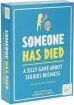 Someone Has Died game by Gather Round Games features a vibrant blue box with playful typography. The title is prominently displayed in bold letters, accompanied by illustrations of quirky characters, enticing players to engage in a fun and silly game about solving mysteries. Ideal for game nights with friends or family.