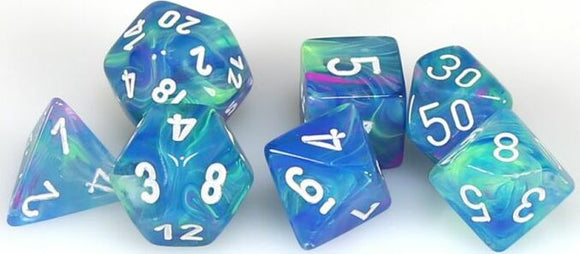 A collection of colorful polyhedral dice in shades of blue and green, featuring white numbers. The set includes various shapes like a d20, d12, and d10, perfect for tabletop games.