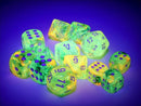 A vibrant assortment of translucent, glow-in-the-dark dice in shades of green and yellow, featuring purple numbers. The collection includes various polyhedral shapes suitable for tabletop games, highlighting their luminous qualities against a dark background.