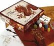 Tsuro game by Calliope, featuring a beautifully designed box with a dragon motif. The box is open to reveal colorful game pieces and game board elements on a warm-colored surface.