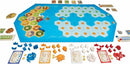 Catan: Explorers & Pirates board game layout showcasing various hexagonal tiles representing land and sea. The game features multiple colors of game pieces: buildings, ships, and resource tokens arranged around the board, along with development cards and game rule cards, creating an immersive strategic gameplay environment.